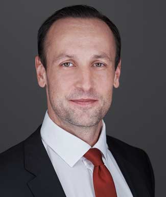 man wearing suit white shirt and red tie